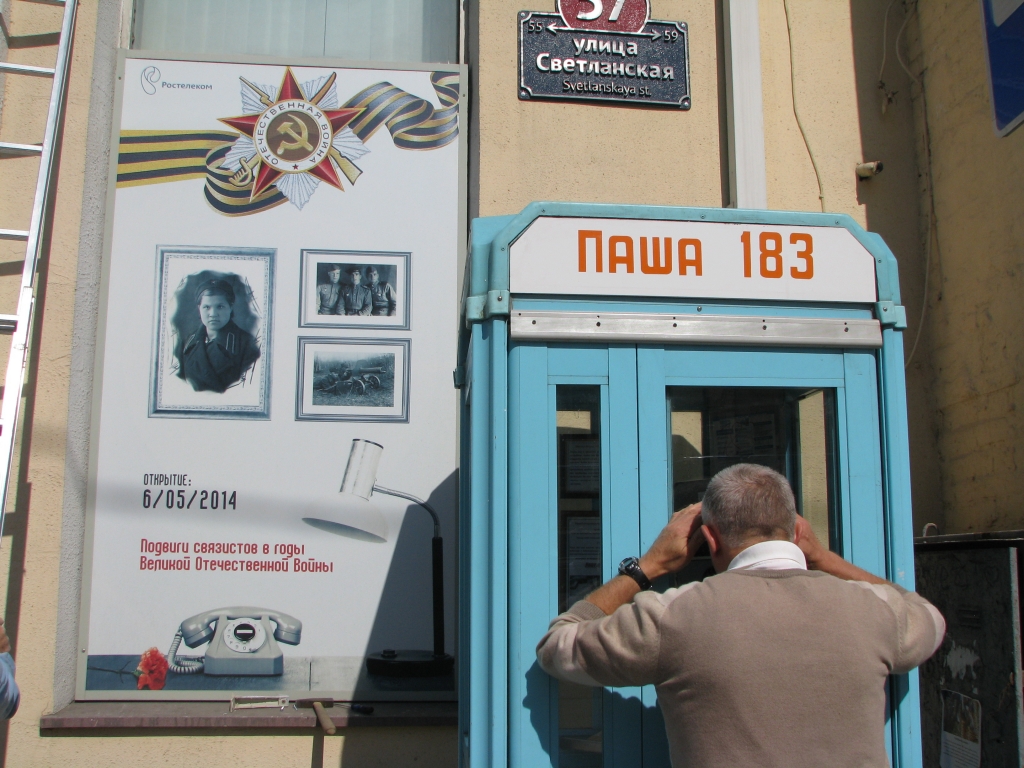 Прохожие активно рассматривают телефонную будку, Фото с места события собственное